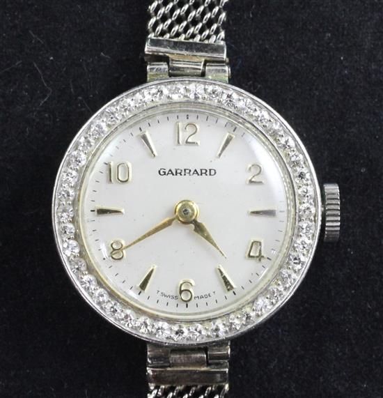 A ladys 1950s Swiss platinum and diamond set cocktail watch retailed by Garrard,